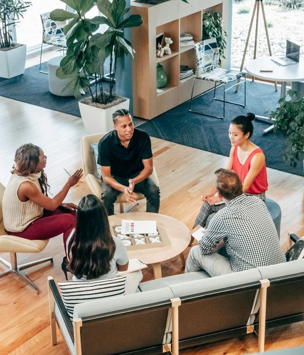 Diverse group of professionals looking calm and focused in an office.